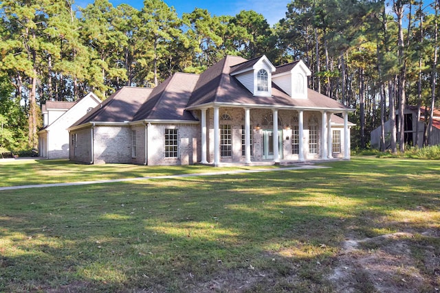 cape cod-style house with a front lawn and covered porch