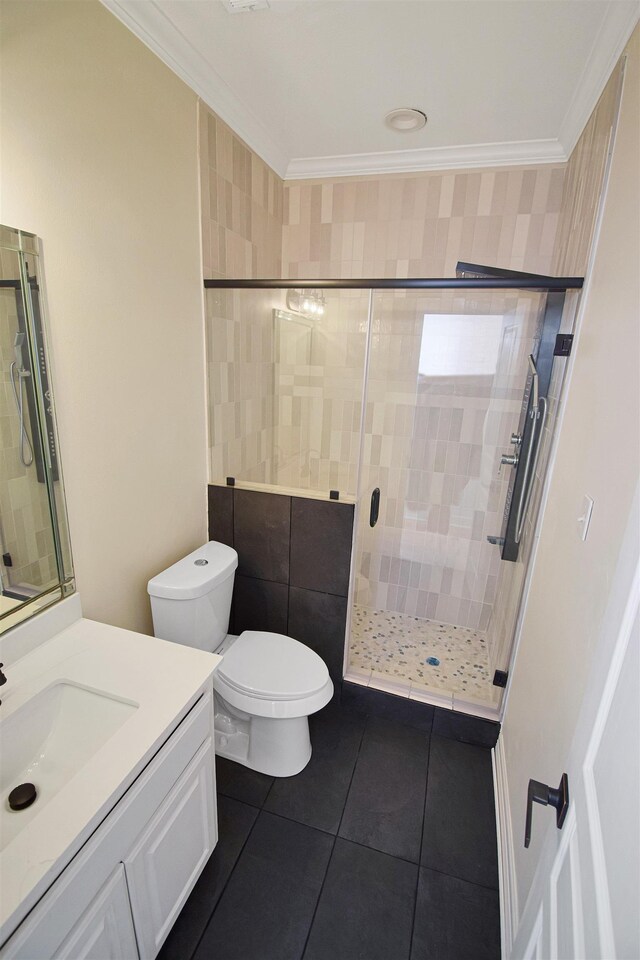 bathroom with toilet, vanity, an enclosed shower, and ornamental molding