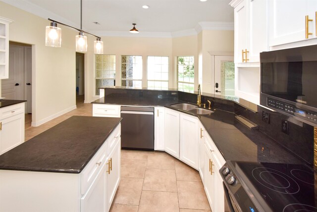 kitchen featuring stainless steel appliances, sink, light tile patterned floors, dark stone countertops, and white cabinets