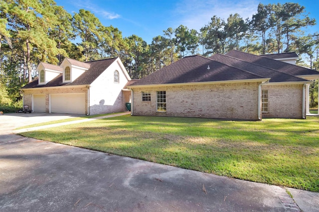 view of front of home with a garage and a front lawn