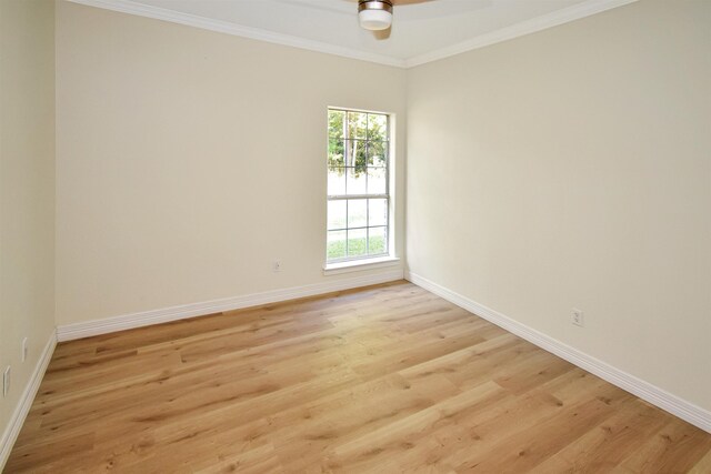 empty room featuring ceiling fan, light hardwood / wood-style flooring, and ornamental molding