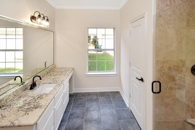 bathroom with vanity, an enclosed shower, and ornamental molding