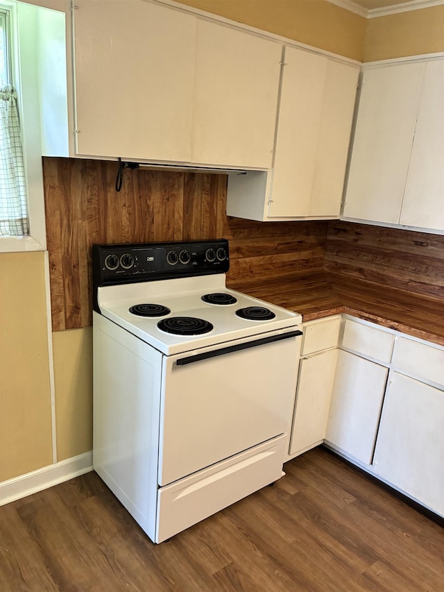 2515 Glenwood Dr, Port Arthur, TX 77642 - kitchen with white range with electric cooktop, white cabinets, dark wood-type flooring, ornamental molding, and dark countertops