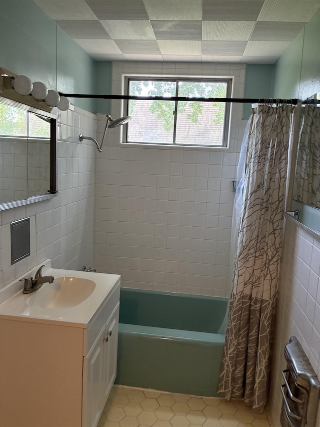 2515 Glenwood Dr, Port Arthur, TX 77642 - bathroom with shower / bath combination with curtain, tile walls, vanity, tile patterned flooring, and radiator
