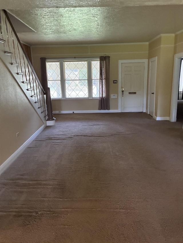 2515 Glenwood Dr, Port Arthur, TX 77642 - carpeted foyer featuring stairs and a textured ceiling
