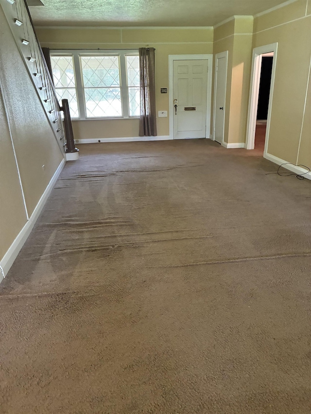 2515 Glenwood Dr, Port Arthur, TX 77642 - unfurnished living room featuring carpet floors and stairs