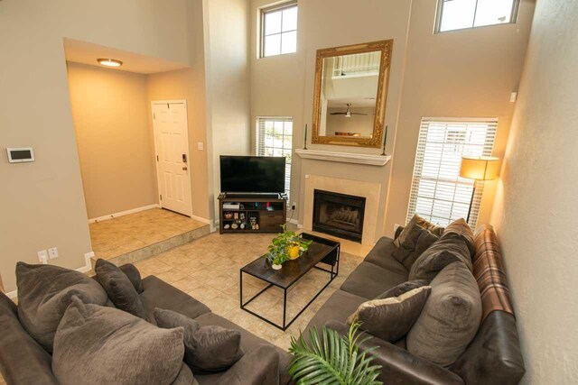 1620 Wellington Pl, Beaumont, TX 77706 - living area featuring a high ceiling, baseboards, a fireplace, and tile patterned floors