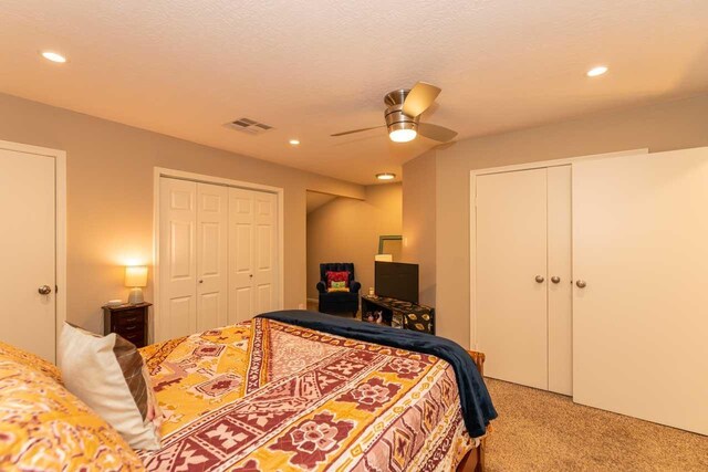 1620 Wellington Pl, Beaumont, TX 77706 - bedroom with two closets, light colored carpet, recessed lighting, and a ceiling fan