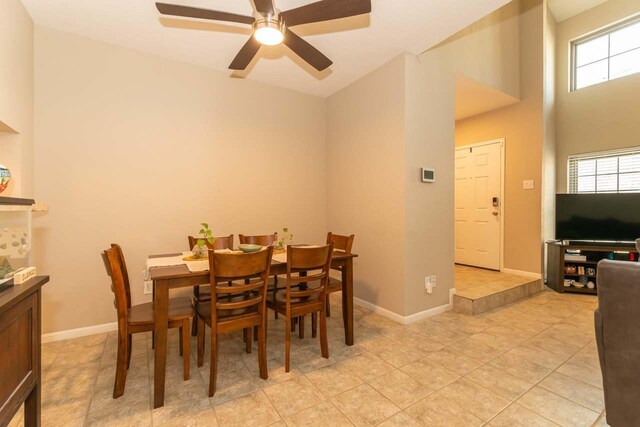 1620 Wellington Pl, Beaumont, TX 77706 - dining room with a ceiling fan, light tile patterned flooring, baseboards, and a high ceiling