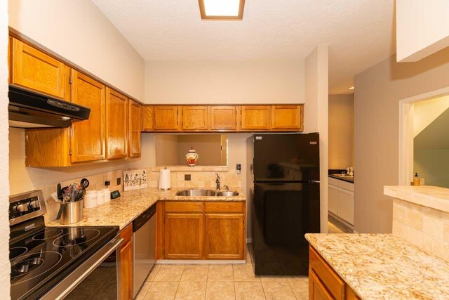 1620 Wellington Pl, Beaumont, TX 77706 - kitchen with stainless steel appliances, a sink, ventilation hood, brown cabinetry, and tasteful backsplash