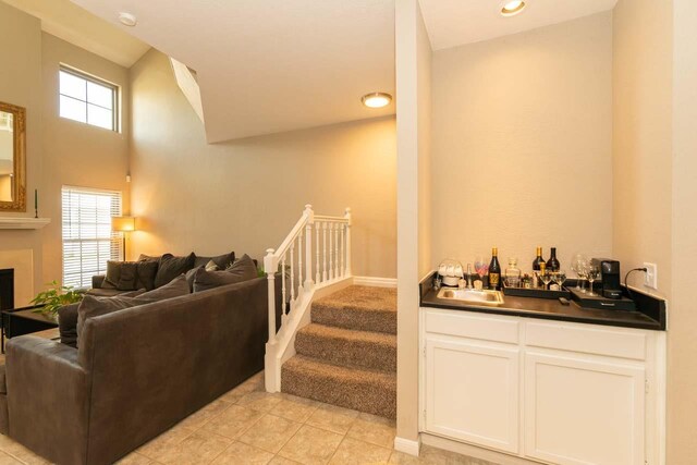 1620 Wellington Pl, Beaumont, TX 77706 - indoor wet bar with light tile patterned floors, baseboards, stairs, and a fireplace
