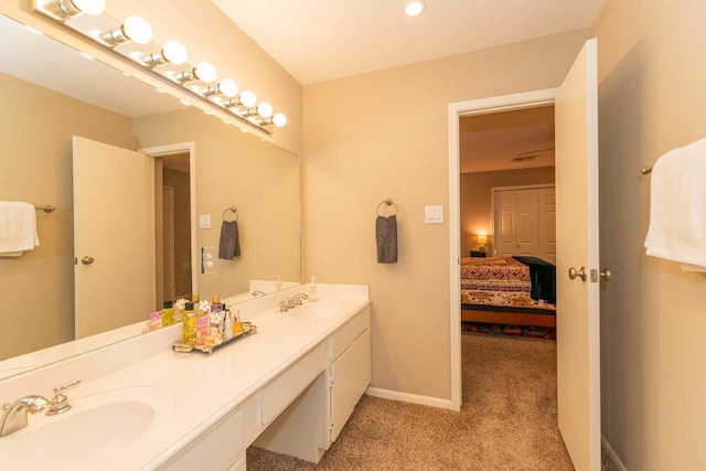 1620 Wellington Pl, Beaumont, TX 77706 - ensuite bathroom with double vanity and baseboards
