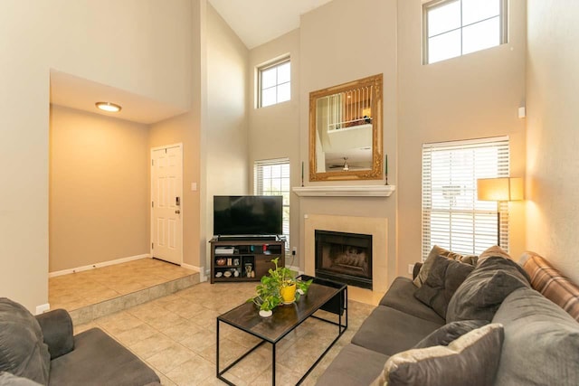 1620 Wellington Pl, Beaumont, TX 77706 - tiled living room with a towering ceiling, a fireplace with flush hearth, and baseboards
