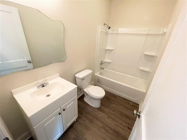 full bathroom with vanity, shower / bath combination, hardwood / wood-style flooring, and toilet