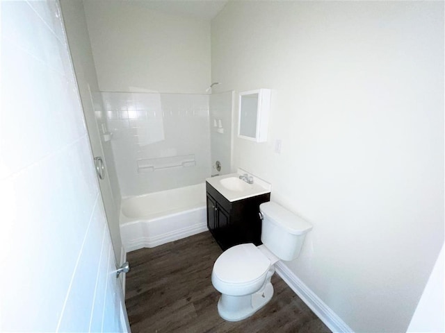 full bathroom featuring hardwood / wood-style floors, vanity, toilet, and shower / tub combination