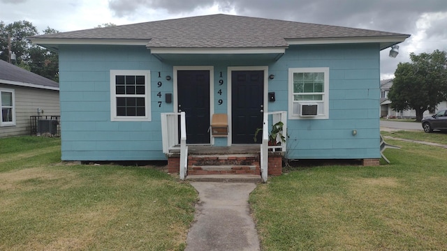 bungalow-style home with a front lawn