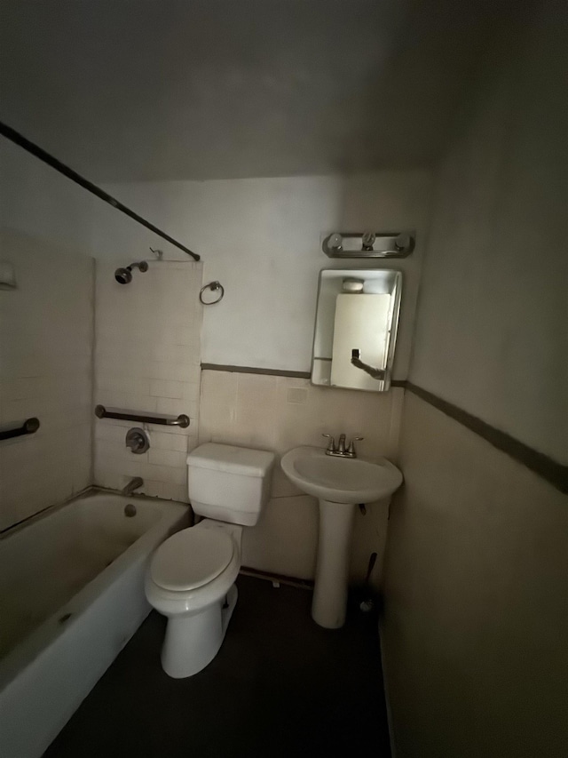 full bathroom featuring sink, shower / bathing tub combination, tile walls, and toilet