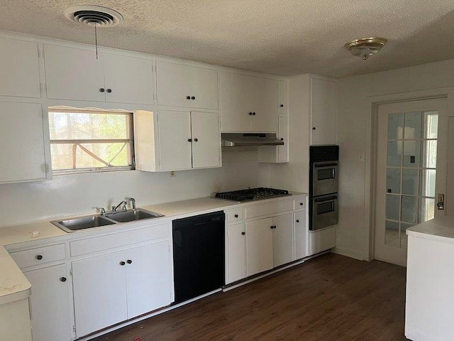 kitchen featuring dark wood-type flooring, white cabinetry, sink, and stainless steel appliances