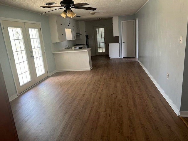 kitchen featuring dark wood-type flooring, french doors, ceiling fan, a textured ceiling, and white cabinetry