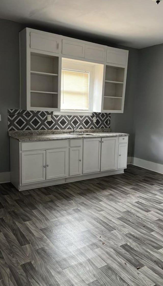 kitchen with white cabinets, dark hardwood / wood-style flooring, and sink