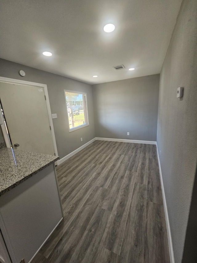 unfurnished dining area featuring dark hardwood / wood-style floors