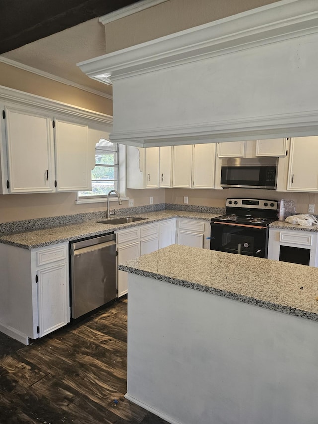 kitchen with white cabinetry, sink, light stone countertops, crown molding, and appliances with stainless steel finishes