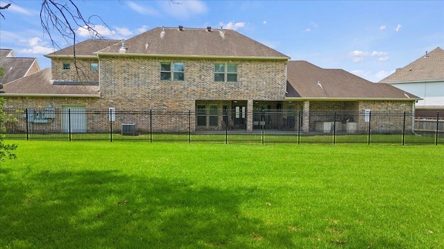 rear view of house with a yard