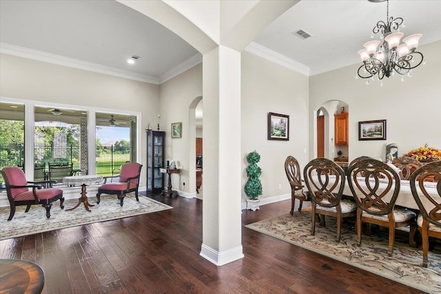 dining area featuring crown molding, dark hardwood / wood-style flooring, and a notable chandelier