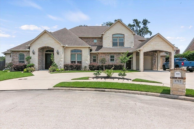 french provincial home featuring a garage