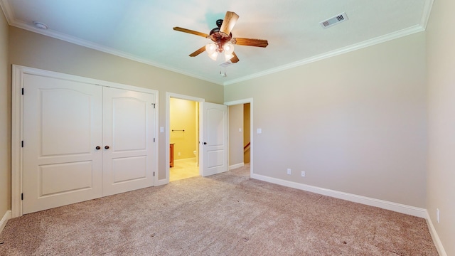 unfurnished bedroom with a closet, light colored carpet, ceiling fan, and ornamental molding