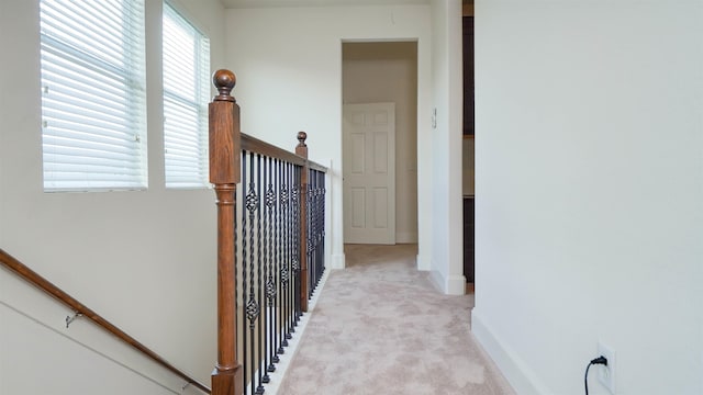 2650 Cedar Spgs, Port Arthur, TX 77640 - hallway featuring an upstairs landing, light carpet, and baseboards
