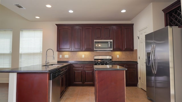 2650 Cedar Spgs, Port Arthur, TX 77640 - kitchen featuring appliances with stainless steel finishes, a sink, dark countertops, dark brown cabinets, and recessed lighting