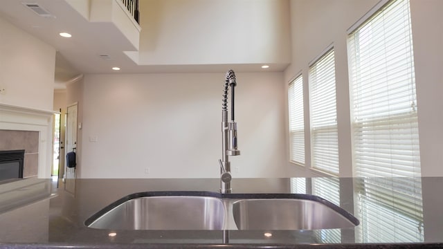 2650 Cedar Spgs, Port Arthur, TX 77640 - kitchen with a sink, recessed lighting, a tiled fireplace, and dark stone countertops