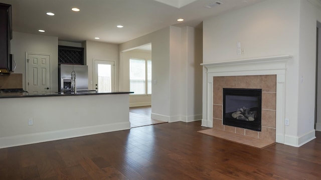 2650 Cedar Spgs, Port Arthur, TX 77640 - unfurnished living room with wood finished floors, recessed lighting, baseboards, and a fireplace