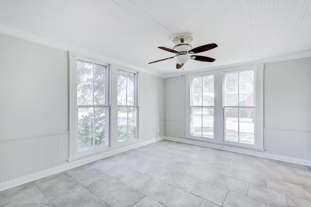 unfurnished room featuring ceiling fan and crown molding