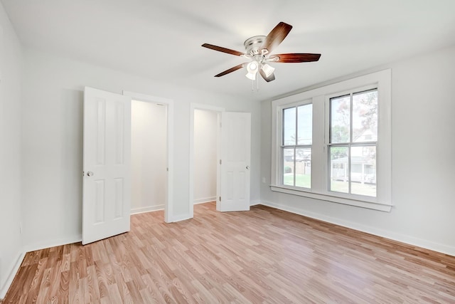 unfurnished bedroom featuring ceiling fan and light wood-type flooring