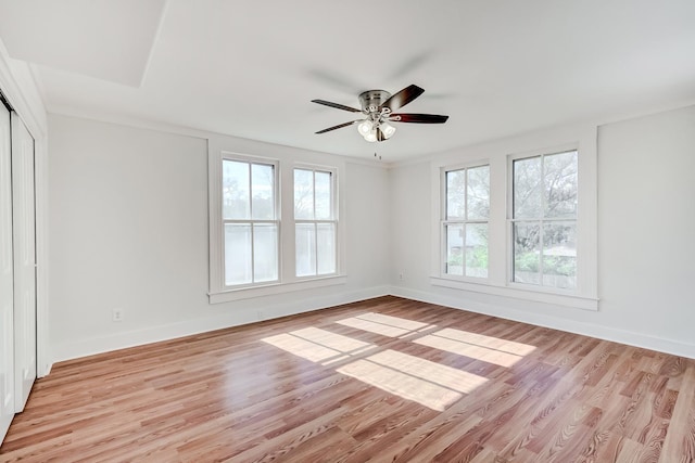 spare room with light wood-type flooring and ceiling fan