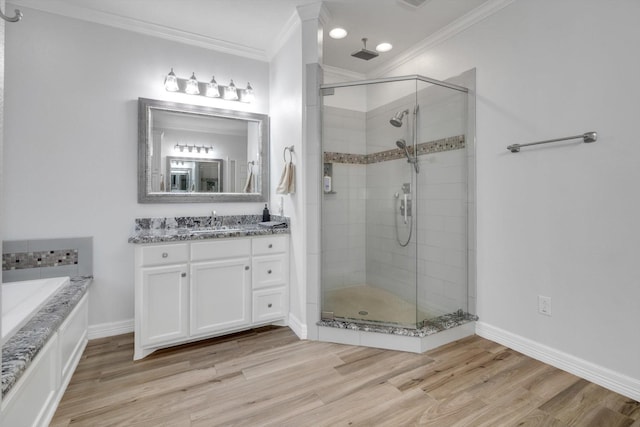 bathroom featuring wood-type flooring, vanity, shower with separate bathtub, and ornamental molding