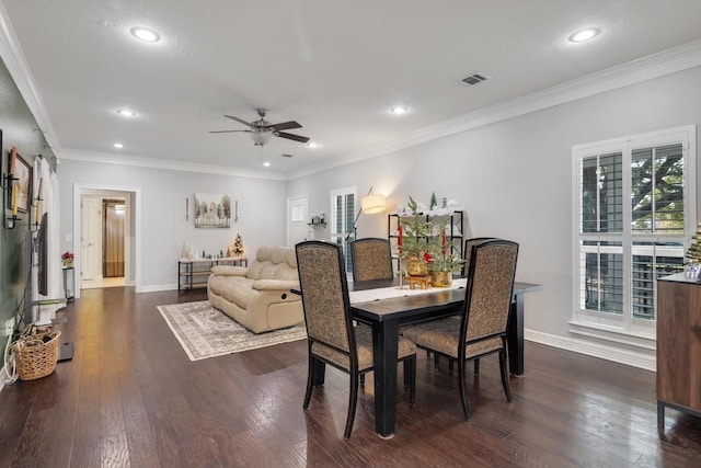 dining room featuring dark hardwood / wood-style floors, ceiling fan, and crown molding