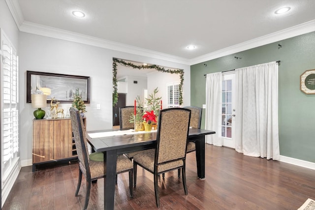 dining area with dark hardwood / wood-style flooring and crown molding