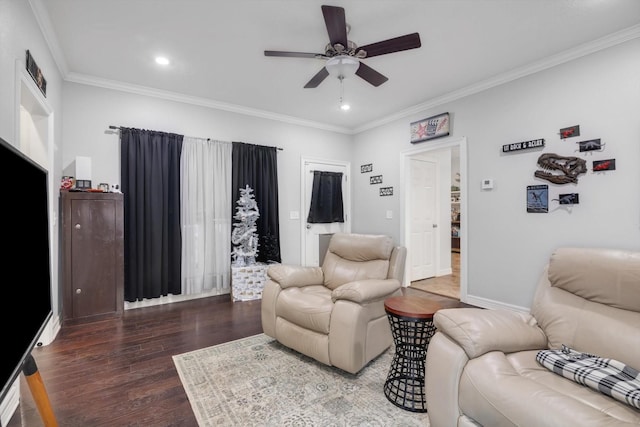 living room with crown molding, ceiling fan, and dark wood-type flooring