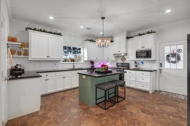 kitchen featuring white cabinetry, black microwave, and sink