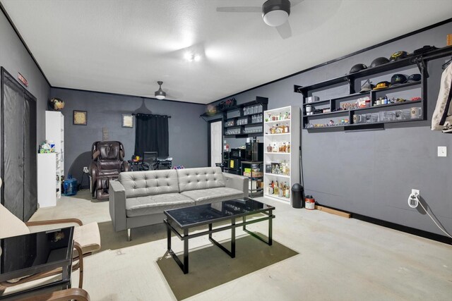 living room featuring ceiling fan and concrete flooring