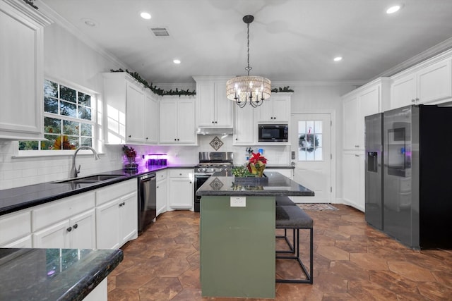 kitchen featuring black appliances, white cabinets, sink, hanging light fixtures, and a kitchen island