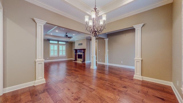 unfurnished living room featuring ceiling fan with notable chandelier, crown molding, and a tray ceiling