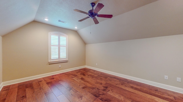 bonus room with a textured ceiling, ceiling fan, hardwood / wood-style floors, and vaulted ceiling