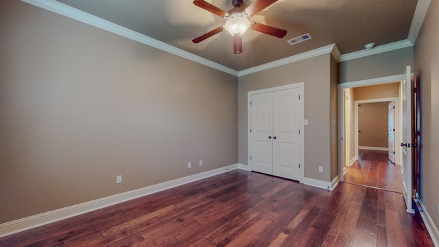 unfurnished bedroom with dark hardwood / wood-style flooring, a closet, ceiling fan, and crown molding