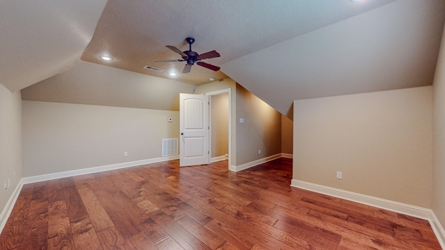 bonus room with a textured ceiling, ceiling fan, vaulted ceiling, and hardwood / wood-style flooring