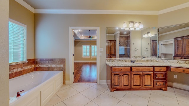 bathroom with a bathtub, ornamental molding, vanity, ceiling fan, and tile patterned flooring