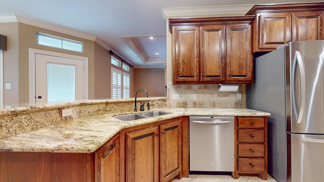 kitchen with backsplash, ornamental molding, sink, and appliances with stainless steel finishes